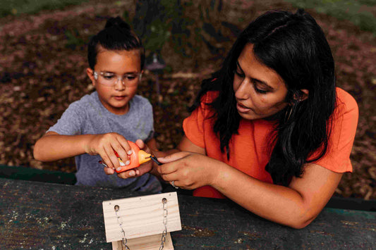 Mother helping her daughter with a measuring tape