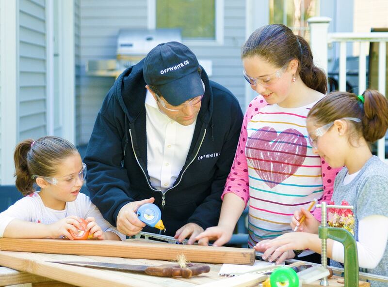 HandyFamm founder Josh White building a woodworking project with his daughters wearing safety glasses and using real kids tools